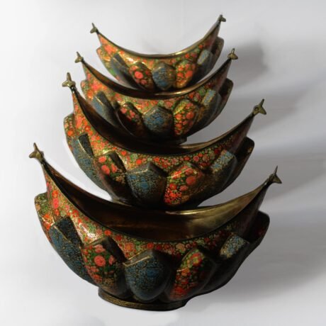 Paper Mache and Brass Fruit Bowls Set Description: Elevate your home or office decor with our stunning set of four Paper Mache and Brass Fruit Bowls, meticulously handcrafted to bring elegance and artistry to any space. This exquisite collection features delicate floral motifs in multiple colors, inspired by the traditional Hazara design. Each bowl is a masterpiece of craftsmanship, with lacquered, layered paper mache intricately embossed into a thick petal-type surface, set within a boat-shaped brass bowl. Product Details: Set: Set of 4 Fruit Bowls Materials: Paper Mache and Brass Dimensions: Lengthwise - 30 cm, 27 cm, 23 cm, 20 cm