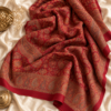 Red jamawar bridal shawl styled as a flat lay