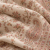Close-up of delicate ivory sozni embroidery